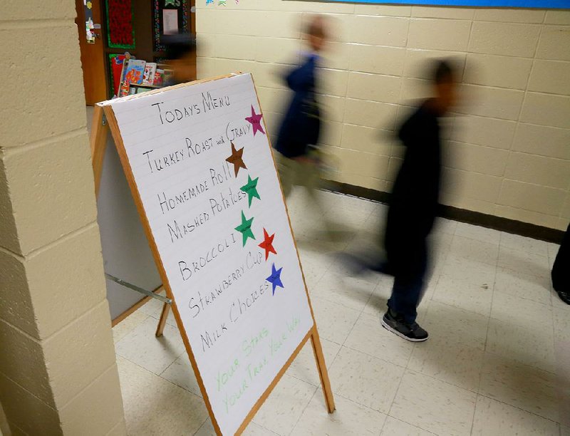 Otter Creek Elementary School students pass a color-coded list of lunch menu items at the Little Rock school in this 2013 file photo.