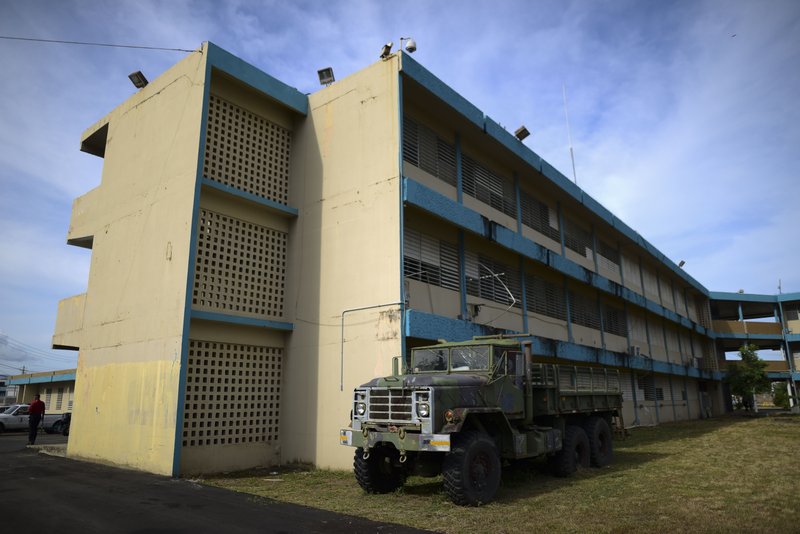 An old military truck used during flooding sits parked at the Carlos Escobar Lopez vocational school which will be used as a shelter during this year's hurricane season in Loiza, Puerto Rico, Thursday, May 28, 2020. Caribbean islands have rarely been so vulnerable as an unusually active hurricane season threatens a region still recovering from recent storms as it fights a worsening drought and a pandemic that has drained budgets and muddled preparations. (AP Photo/Carlos Giusti)