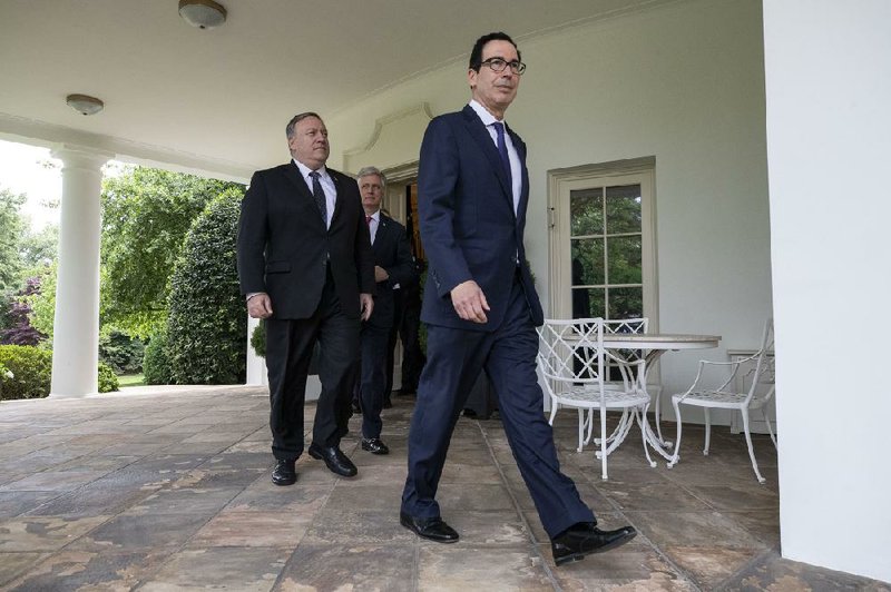 Secretary of State Mike Pompeo (center) steps out of the Oval Office with Treasury Secretary Steven Mnuchin (right), national security adviser Robert O’Brien and others to stand with President Donald Trump at a Rose Garden event Friday.
(AP/Alex Brandon)