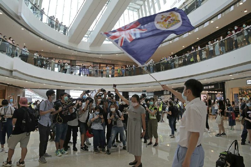 Dozens of people gather Friday at a Hong Kong mall to protest the new national security law passed in China for the semiautonomous city. More photos at arkansasonline.com/530hongkong/.
(AP/Kin Cheung)