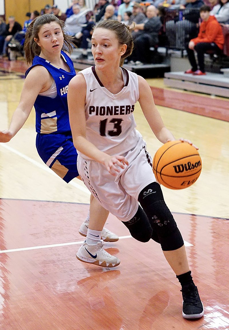 Randy Moll/Westside Eagle Observer Gentry senior Ariel Nix dribbles past Harrison sophomore Camryn Casey during play in Gentry on Friday, Jan. 24, 2020. Nix is one of eight players to sign with John Brown University's women's basketball program.