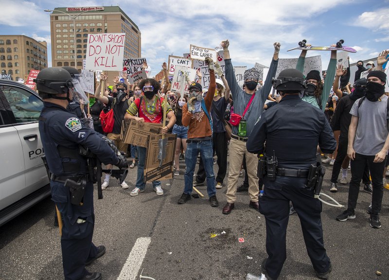 Protesters face off with police as they shut down southbound Interstate 35 freeway in Austin Texas, Saturday, May 30, 2020. Demonstrators were protesting the death of George Floyd, a black man who was killed in police custody in Minneapolis on May 25. (Ricardo B. Brazziell/Austin American-Statesman via AP)