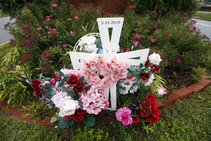 Flowers and a cross mark the entrance to Jason Nixon’s neighborhood in Virginia Beach, Va., in this photo taken May 22. The flowers are a memorial to Kate Nixon, who was killed in last year’s shootings at a Virginia Beach municipal building. More photos at arkansasonline.com/531vabeach/.
(AP/Steve Helber)