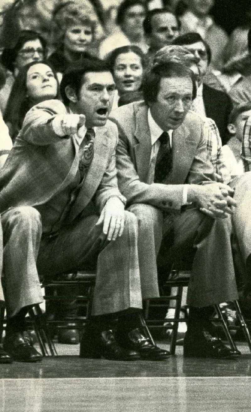 Former Arkansas coach Eddie Sutton (left), who died last week, coaches during a game in 1979 at Barnhill arena in Fayetteville. In 11 seasons coaching the Razorbacks, Sutton was 120-8 at Barnhill. (Arkansas democrat-Gazette file photo) 