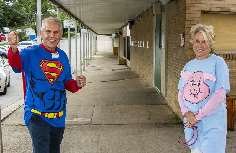 Aaron Lubin and Beth Mason like to wear fun costumes when escorting children to their classrooms at Pulaski Heights Elementary and Middle schools. Both are members of Rotary Club 99 of Little Rock, a nonprofit organization that is working with the Little Rock School District to help make sure children of critical employees at the University of Arkansas for Medical Sciences have a good experience at a day camp at the school. 
(Arkansas Democrat-Gazette/Cary Jenkins) 