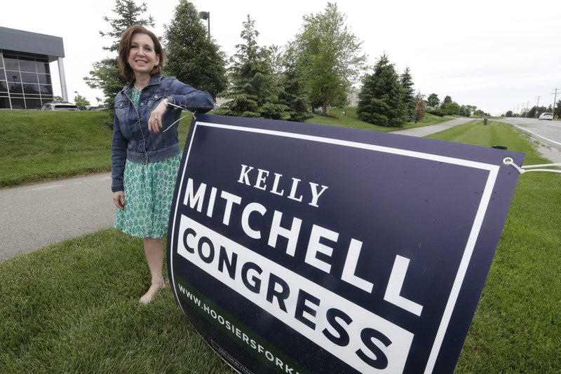 Indiana State Treasurer Kelly Mitchell stands by a campaign sign Thursday in Westfield, Ind. Mitchell is a candidate for Indiana's 5th Congressional District. More Republican women than ever are seeking House seats this year after the 2018 election further diminished their limited ranks in Congress. But so far it appears that any gains this November could be modest. - AP Photo/Darron Cummings