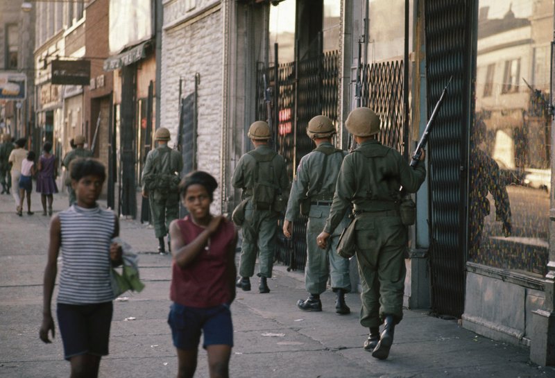 In this April 6, 1968, file photo, National Guard patrol the streets in Chicago following rioting and violence that ensued after the news of the assassination of Dr. Martin Luther King, Jr. - AP Photo/File