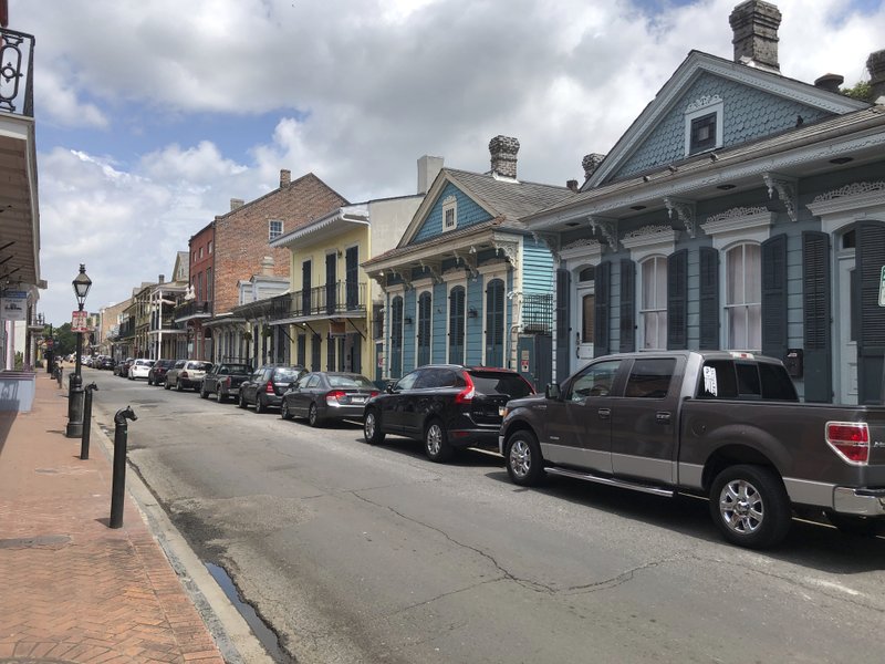This Wednesday, May 20, 2020 photo, shows a row of houses just off Bourbon Street in New Orleans&#x2019; French Quarter. The closure of night clubs and bars on Bourbon and other parts of the quarter during the coronavirus pandemic has brought at least a temporary end to tensions between some entertainment venues and some residents who say the balance between the interests of businesses and residents who own or rent homes in the historic district has been upset by a growing number of tourists. (AP Photo/Kevin McGill)