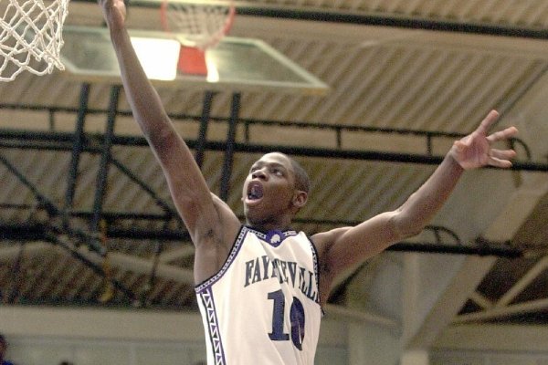 Fayetteville's Ronnie Brewer jumps above Rogers defenders as he attempts a layup during the first half in Fayetteville on Jan. 15, 2002. (Arkansas Democrat-Gazette/Jeremy Scott)