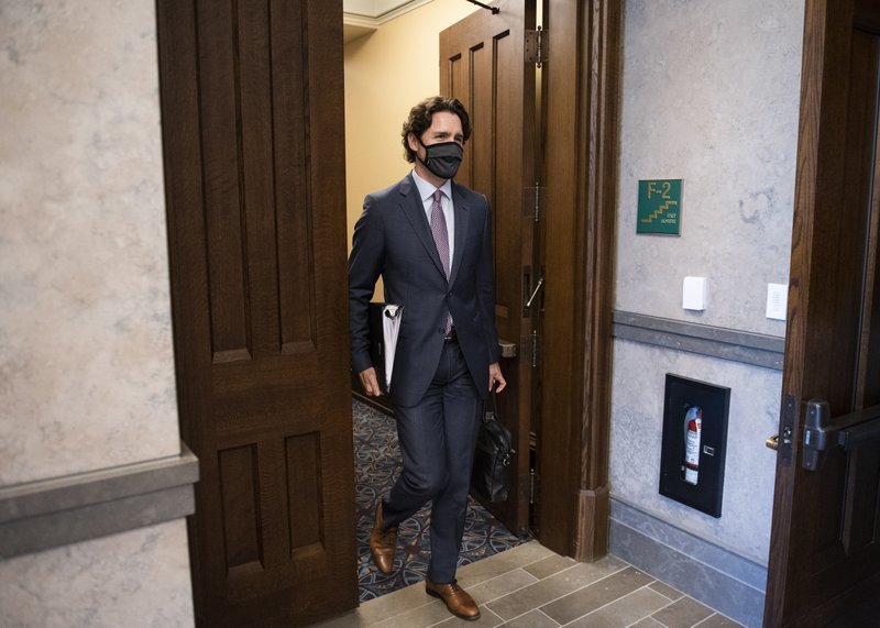 Canada's Prime Minister Justin Trudeau arrives in the foyer of the House of Commons on Parliament Hill for a meeting of the Special Committee on the COVID-19 Pandemic in Ottawa, Ontario on Wednesday, May 27, 2020. (Justin Tang/The Canadian Press via AP)