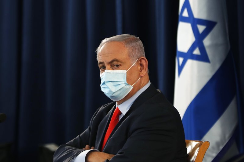 Israeli Prime Minister Benjamin Netanyahu wears a mask as he looks on during the weekly cabinet meeting in Jerusalem Saturday, May 31, 2020. (Ronen Zvulun/Pool Photo via AP)
