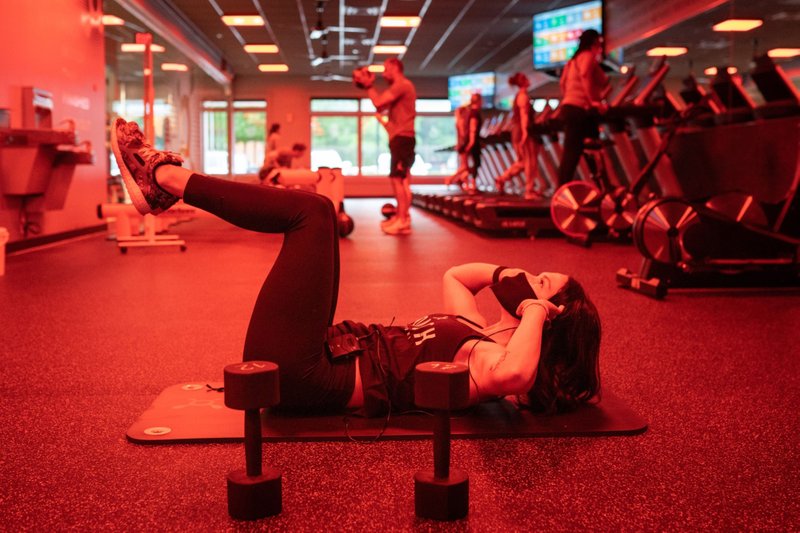 A coach wearing a protective mask models a workout for clients during a class at an Orangetheory Fitness gym in Atlanta, Georgia, on May 27, 2020. MUST CREDIT: Bloomberg photo by Elijah Nouvelage