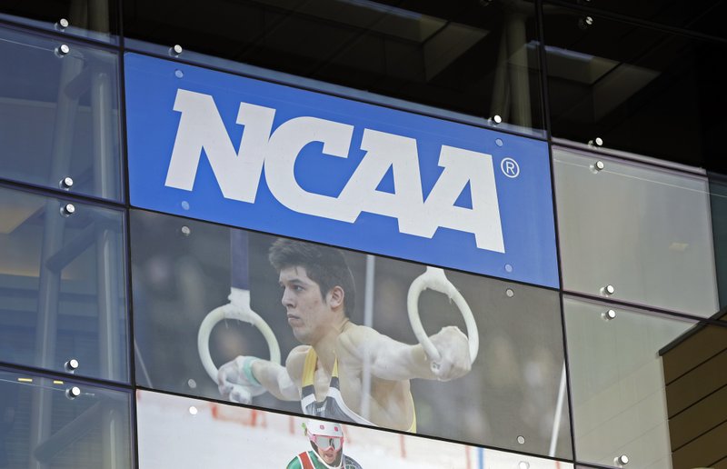 FILE - In this April 25, 2018, file photo, the NCAA headquarters is shown in Indianapolis. More than a dozen national associations in various sports &#x2013; hockey, soccer, tennis, golf, swimming and gymnastics, among them &#x2013; have signed a memo outlining &#x201c;significant concerns&#x201d; about effects of allowing athletes to profit for use of their names, images and likenesses (NIL). (AP Photo/Darron Cummings, File)