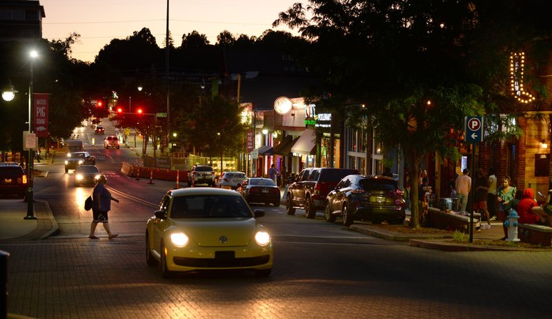 A pedestrian crosses Dickson Street Friday, May 29, 2020, as traffic passes along the street in Fayetteville.
(NWA Democrat-Gazette/Andy Shupe)