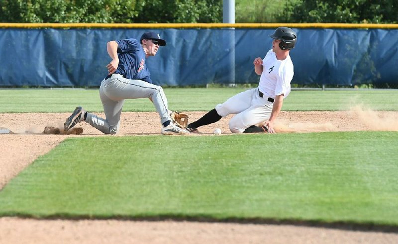 Blaze Brothers slides into second ahead of the tag by Jeb Sample during a Perfect Timing College Baseball League game Monday at Tyson Complex in Springdale. Brothers scored a run as PT White beat PT Blue 2-0. (NWA Democrat-Gazette/J.T. Wampler) 