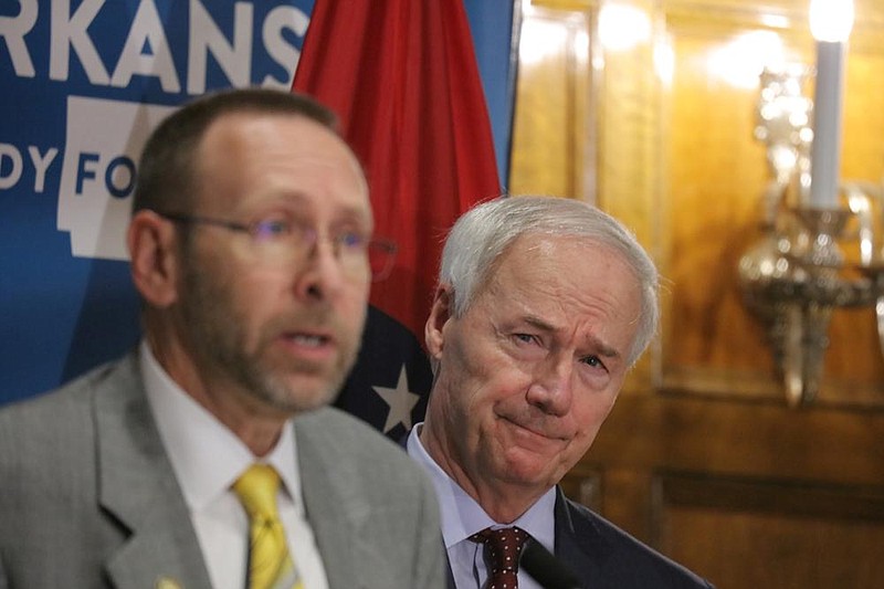 Arkansas Health Secretary Nate Smith, left, along with Governor Asa Hutchinson talks about the effects of the covid-19 virus on the state at the governors conference room Tuesday afternoon, June 2, 2020. (Arkansas Democrat-Gazette/ John Sykes Jr.)