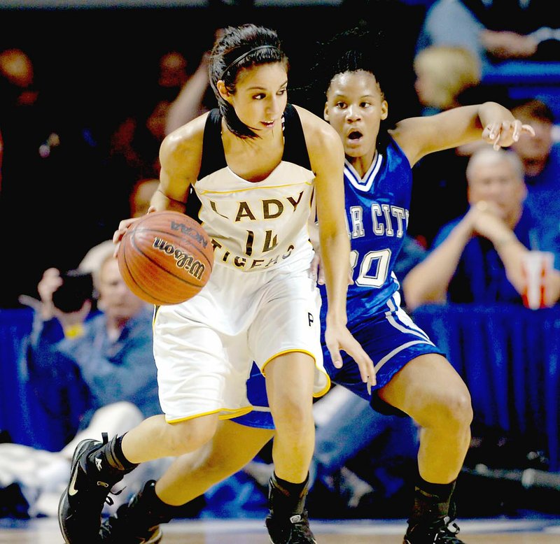 Arkansas Democrat-Gazette/KAREN E. SEGRAVE Prairie Grove's Julie Rutherfors (No. 14) drives past Star City's Queona Walker (No. 30) in the class 4A girls state championship held Thursday, March 11, 2010 at the Summit Arena in Hot Springs. The Lady Tigers won the finals by a score of 59-56. Earlier during their postseason run Prairie Grove defeated Gentry, 71-48, and Shiloh Christian, 52-33, in the District 4A-1 tournament at Farmington's Mryl Massie Gymnasium.