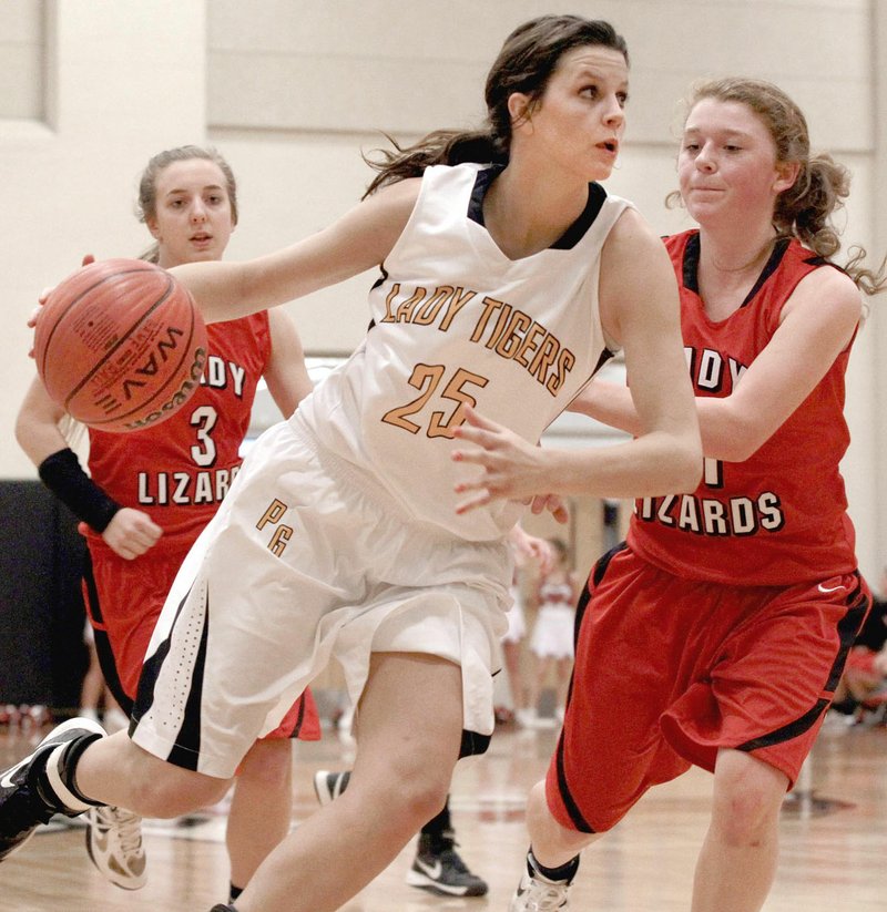 Arkansas Democrat-Gazette/BENJAMIN KRAIN --2/21/13-- Prairie Grove's Justyne Huber, shown as a senior, drives around Dardanelle defender Shelbie Shay during their 4A Regional game at Maumelle High School on Thursday, Feb. 21, 2013. Huber earned a starting spot as a freshman and played a key role in helping Prairie Grove win the 2010 Class 4A State girls basketball championship including a 58-44 win over 4A North Regional tournament host, Clarksville, in the first-round to qualify for state.