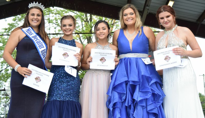 Westside Eagle Observer/MIKE ECKELS The 2019 Miss Decatur Barbecue winner Falyn Cordeiro (left) poses with her court during the 66th Annual Decatur Barbecue festival at Veterans Park August 3, 2019. Cordeiro's court included Destiny Mejia (first runner up), Kaylee Morales (second runner up) Kyleigh McBride, and Legend Kavanaugh (Miss Congeniality). Due to covid-19 concerns, the Decatur Chamber of Commerce canceled this year's barbecue.