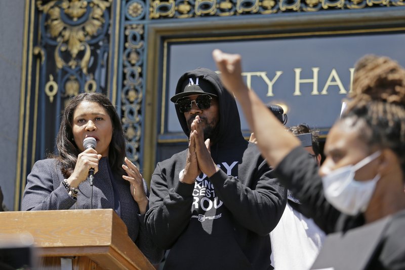 Jamie Foxx and Mayor London Breed take part in a "Kneel-In" to protest police racism on the steps of City Hall, Monday, June 1, 2020, in San Francisco. Hundreds watched the noon time demonstration. (AP Photo/Eric Risberg)