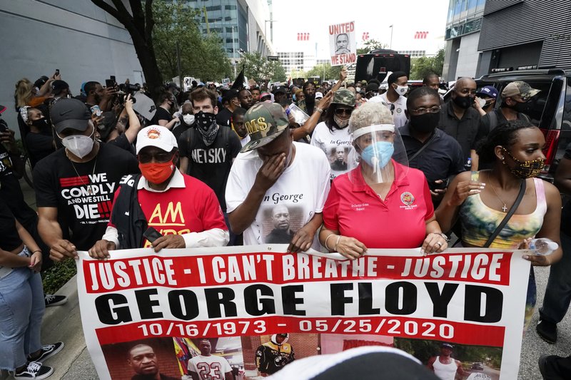 LaTonya Floyd, third from left, participates in a march to protest the death of her brother, George Floyd in Houston on Tuesday, June 2, 2020. Floyd died after a Minneapolis police officer pressed his knee into Floyd's neck for several minutes even after he stopped moving and pleading for air. (AP Photo/David J. Phillip)