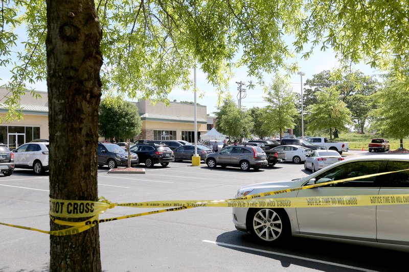 Law enforcement personnel respond Monday, June 1, 2020 to a parking lot near the Community Clinic at 3162 W. Martin Luther King Jr. Blvd. in Fayetteville. U.S. Marshals shot a man Monday morning in his car in the parking lot.(NWA Democrat-Gazette/David Gottschalk)