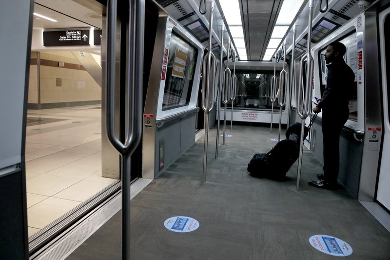 A traveler has a terminal shuttle to himself Monday at Harts eld-Jackson Atlanta International Airport. (AP/Charlie Riedel) 
