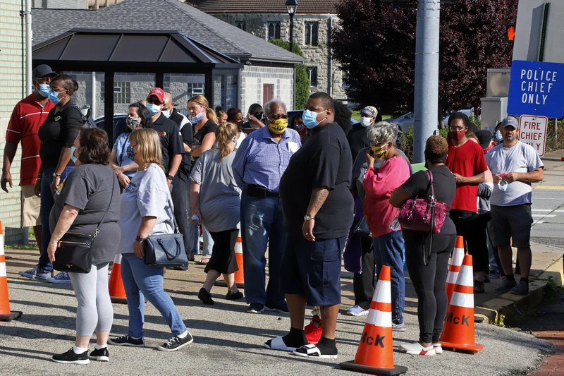 People wait outside the McKeesport Public Safety Building in McKeesport, Pa., before voting in the state’s primary election Tuesday. More photos at arkansasonline.com/63election/. (AP/Gene J. Puskar) 