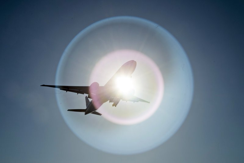 FILE - In this March 18, 2020 file photo, a Southern China Airlines flight from Guangzhou, China passes in front of the sun as it arrives at Vancouver International Airport in Richmond, British Columbia, Canada. On Wednesday, June 3, 2020, the Trump administration moved to block Chinese airlines from flying to the U.S. in an escalation of trade and travel tensions between the two countries. (Jonathan Hayward/The Canadian Press via AP)