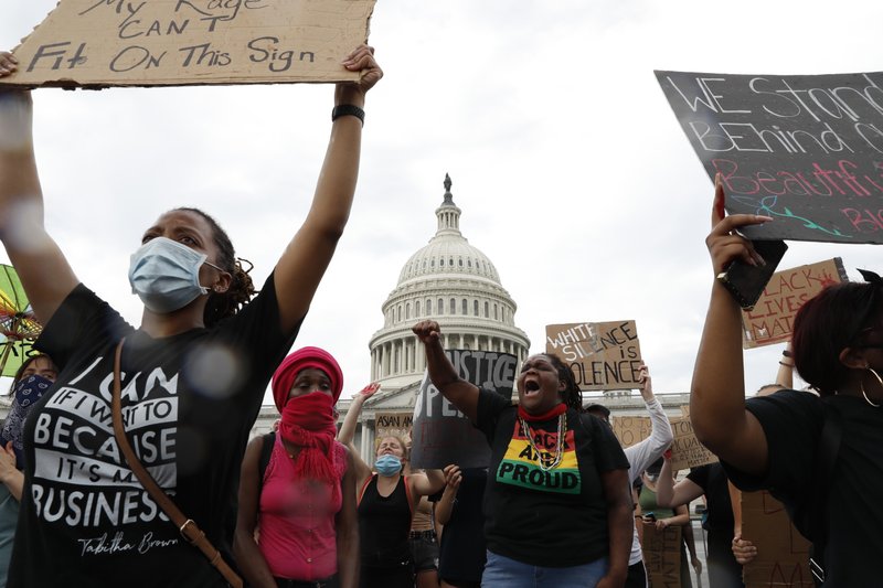 Dominique Bryant, 23, wearing the Black and Proud T-shirt, joins demonstrators as they protest the death of George Floyd, Wednesday, June 3, 2020, outside the U.S. Capitol in Washington. Floyd died after being restrained by Minneapolis police officers. (AP Photo/Jacquelyn Martin)