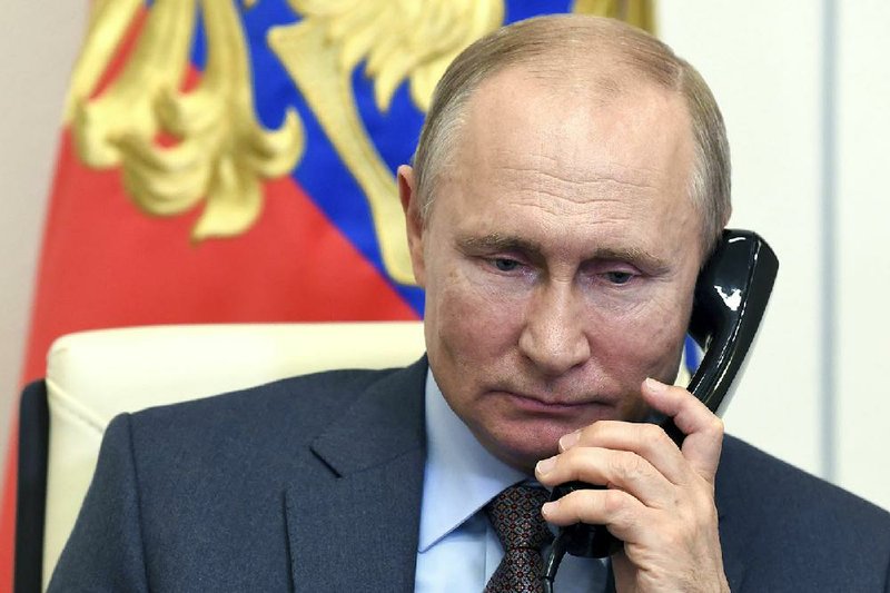 Russian President Vladimir Putin holds a teleconference Tuesday with Russian Prime Minister Mikhail Mishustin from the Novo-Ogaryovo residence outside Moscow. (AP/Sputnik/Alexei Nikolsky) 