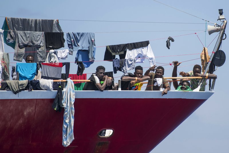 Migrants dry their clothes aboard a tourist boats some 20 kilometers from Malta, Tuesday, June 2, 2020. More than 400 migrants are living aboard pleasure cruise vessels, bobbing in the sea off Malta, many of them for weeks now. Rescued from human traffickers&#x2019; unseaworthy boats in several operations in the central Mediterranean since late April, the migrants, along with the Maltese government, are waiting for European Union countries to offer to take them. (AP Photo/Rene' Rossignaud)