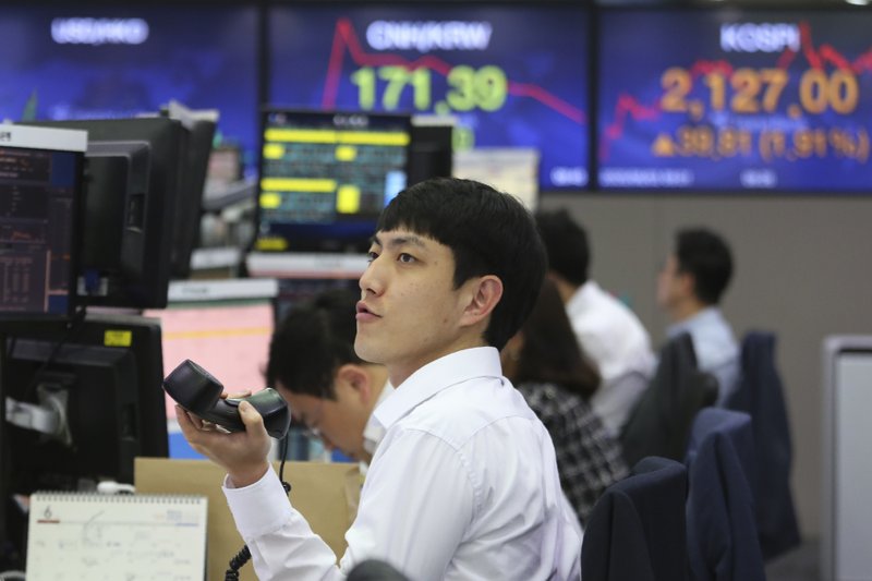 A currency trader watches monitors at the foreign exchange dealing room of the KEB Hana Bank headquarters in Seoul, South Korea, Wednesday, June 3, 2020. Asian shares are rising after Wall Street extended its gains for the third straight day, driven by optimism over economies reopening from shutdowns to stem the coronavirus pandemic. (AP Photo/Ahn Young-joon)
