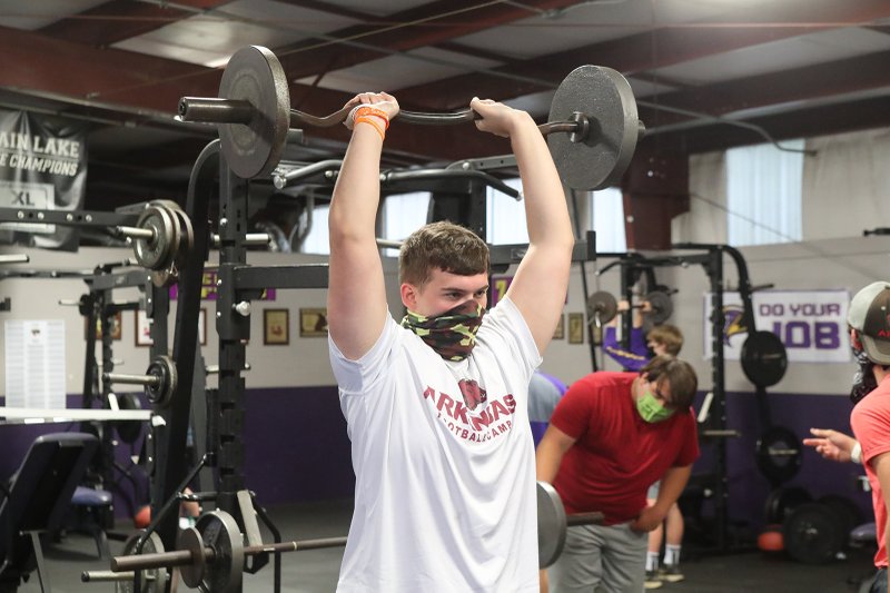Fountain Lake High School football player Kade Shelton lifts weights on the first day of the school's football workouts Tuesday. - Photo by Richard Rasmussen of The Sentinel-Record