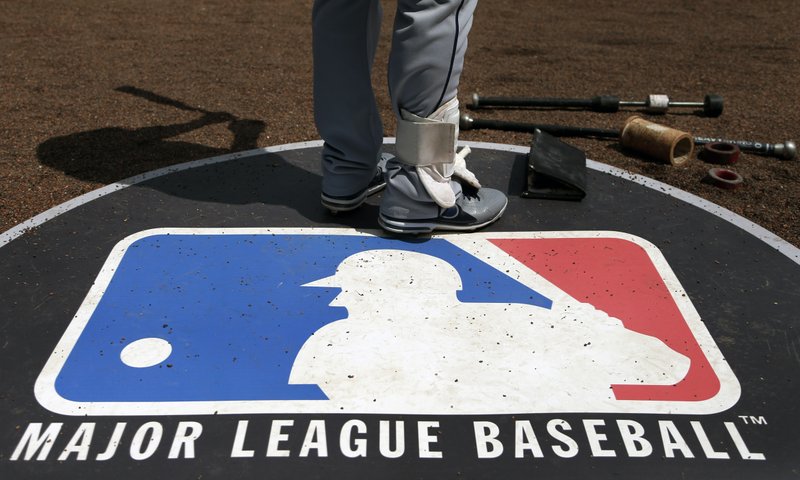File photo from April 24, 2013. The Major League Baseball logo. (AP Photo/Charles Rex Arbogast, File)