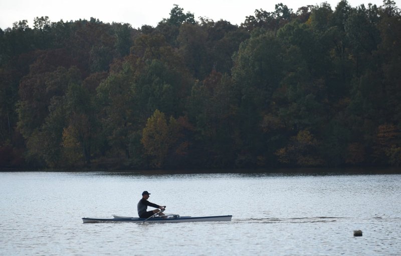 Jim Dehner, a member of the Rowing Club of Northwest Arkansas, oars his 17-foot scull in October at Lake Fayetteville. Harmful levels of algae toxin were detected at the lake. (File photo/NWA Democrat-Gazette/David Gottschalk)