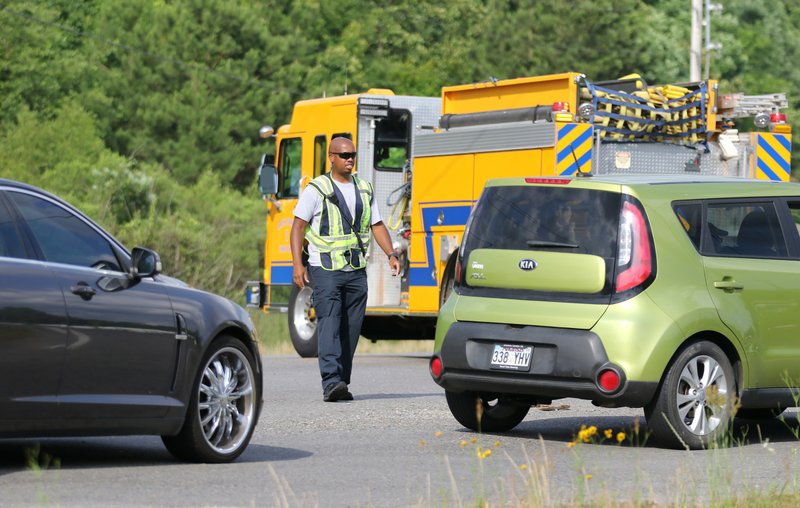 A firefighter with the Arch Street Fire Department directs traffic after Dixon Road in Pulaski County was shut down on Thursday, June 4, 2020. Pulaski County sheriff's deputies and other police agencies were searching for an armed suspect in the area.
