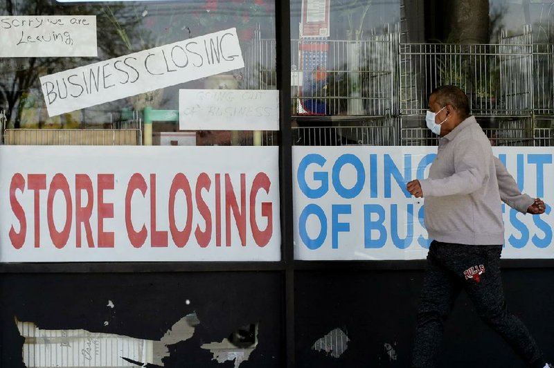 A man passes by a closed store last month in Niles, Ill. The payroll company ADP reported Wednesday that businesses have cut a combined 22.6 million jobs since March.
(AP/Nam Y. Huh)