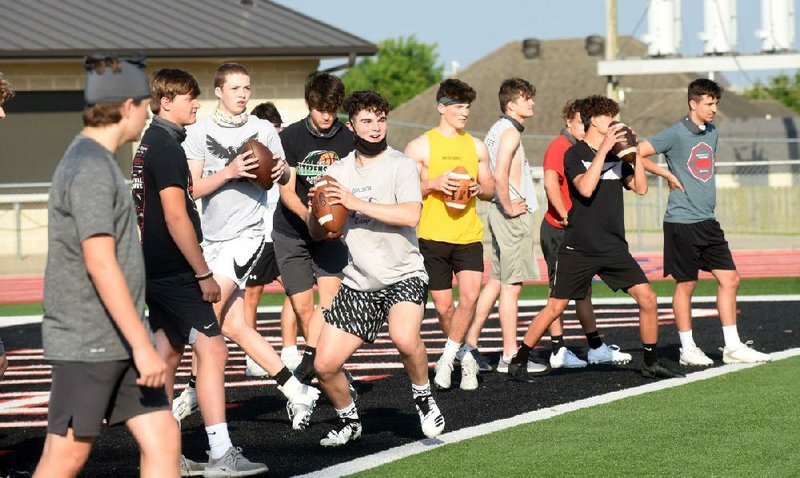 Zak Withrow (center) goes through passing drills on Wednesday June 3 2020 with his Pea Ridge Blackhawks teammates. Go to nwaonline.com/200604Daily/ to see more photos.
(NWA Democrat-Gazette/Flip Putthoff)