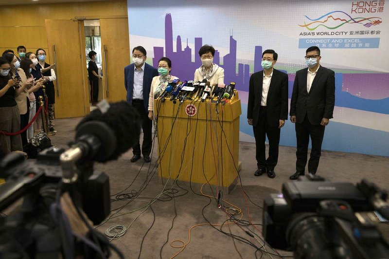 Hong Kong leader Carrie Lam (at lectern) speaks Wednesday after meeting with Chinese leaders in Beijing. Lam said China has the right to pass legislation protecting national security.
(AP/Ng Han Guan)