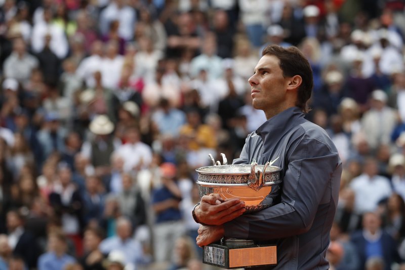 In this June 9, 2019, file photo, Spain's Rafael Nadal celebrates his record 12th French Open tennis tournament title after winning the men's final against Austria's Dominic Thiem at Roland Garros stadium in Paris. If not for the coronavirus pandemic, the second week of the French Open this week would have had fourth-round matches, quarterfinals, semifinals and the final for men and women. Nadal could have been trying to add to his 12 trophies at Roland Garros. (AP Photo/Christophe Ena, File)