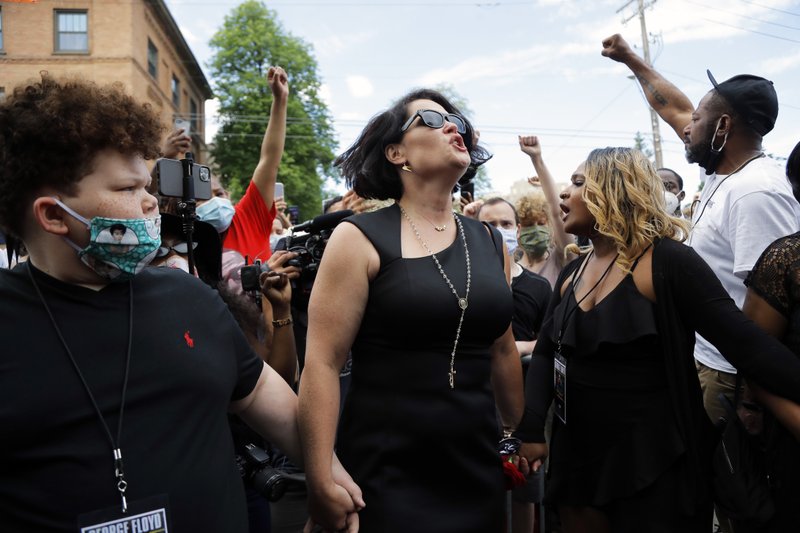 CORRECTS FLOYD'S FIANCEE'S NAME TO COURTENEY ROSS, NOT DIAMOND - Courteney Ross, the fiancee of George Floyd reacts after a memorial service for Floyd at North Central University Thursday, June 4, 2020, in Minneapolis. (AP Photo/Julio Cortez)