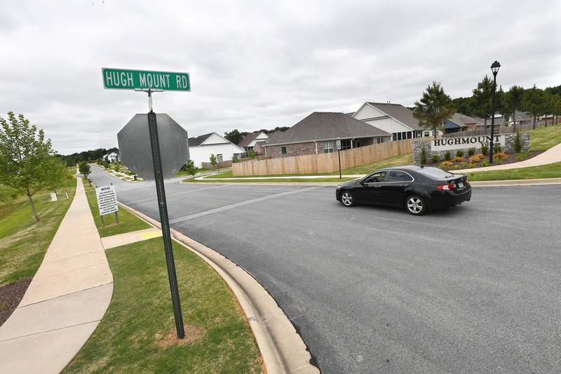 A car turns west May 19 onto Canyon Run Drive from Hughmount Road in Fayetteville. The City Council approved annexing about 152 acres near Hughmount Road. (File photo/NWA Democrat-Gazette/J.T. Wampler)