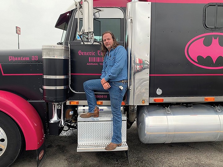 Chad Fowler of Conway stands in front of his 1996 Peterbilt 379 semi, which is custom-fitted with solar panels, as well as the Batman logo. He said everything on his truck holds a special meaning.