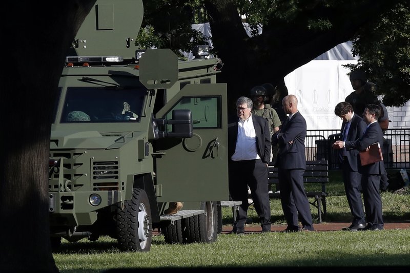 Attorney General William Barr, center, stands in Lafayette Park across from the White House as demonstrators gather to protest the death of George Floyd, Monday,in Washington. Floyd died after being restrained by Minneapolis police officers. - AP Photo/Alex Brandon