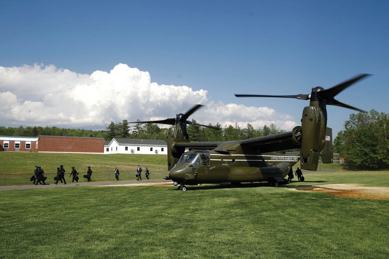 Crew members walk off a Marine Corps MV-22 Osprey on Friday in Guilford, Maine, in advance of the arrival of Marine One with President Donald Trump aboard.
(AP/Patrick Semansky)