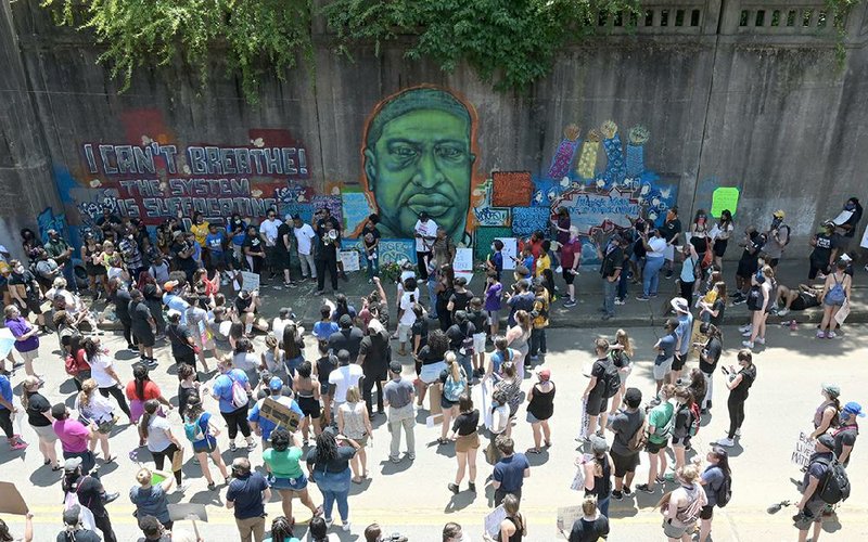 Protesters listen to students talk about racial inequality Friday after marching peacefully from the state Capitol to a mural of George Floyd on Seventh Street in downtown Little Rock. More photos at arkansasonline.com/66protest/.
(Arkansas Democrat-Gazette/Stephen Swofford)