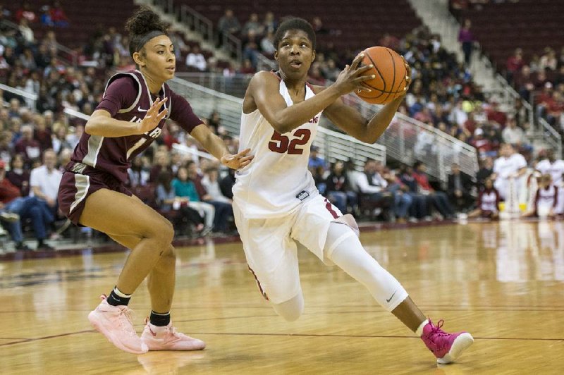 Arkansas guard Rokia Doumbia (right) drives past UALR guard Skyla Knight in a 2019 game. 
(Arkansas Democrat-Gazette file photo)