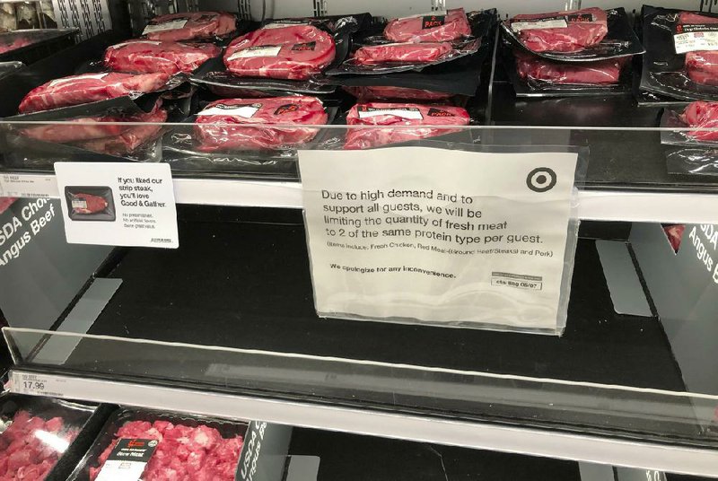 A sign explaining a limit on meat purchases hangs on a display case in a Westminster, Colo., Target store in May as cattle sales faltered in the pandemic.
(AP/David Zalubowski)