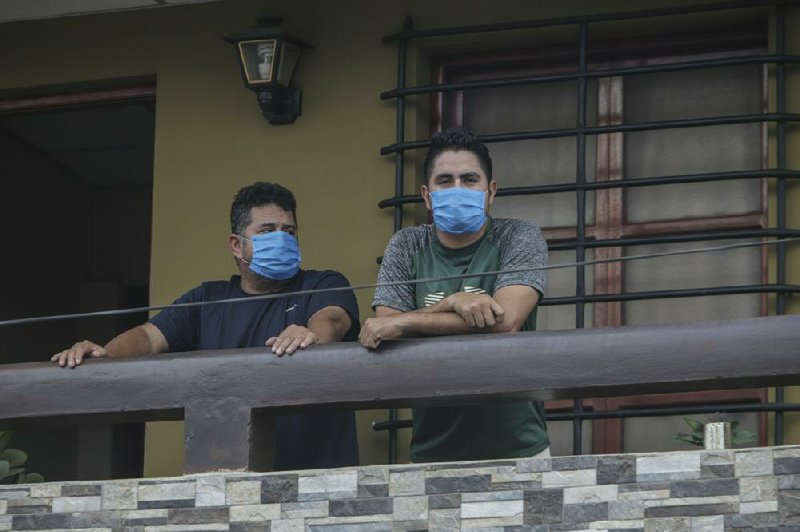 Norman Cardoze Sr. (left) and his son Norman Cardoze Jr. stand on the balcony of their home in Nicaragua where they are in quarantine after contracting covid-19 in May. During a May 16 game, manager Cardoze Sr. and coach Carlos Aranda felt sick. Cardoze’s son Norman Jr., the team’s star slugger, also was sick. Within two days all three men were hospitalized, and Aranda later died.
(AP/Alfredo Zuniga)